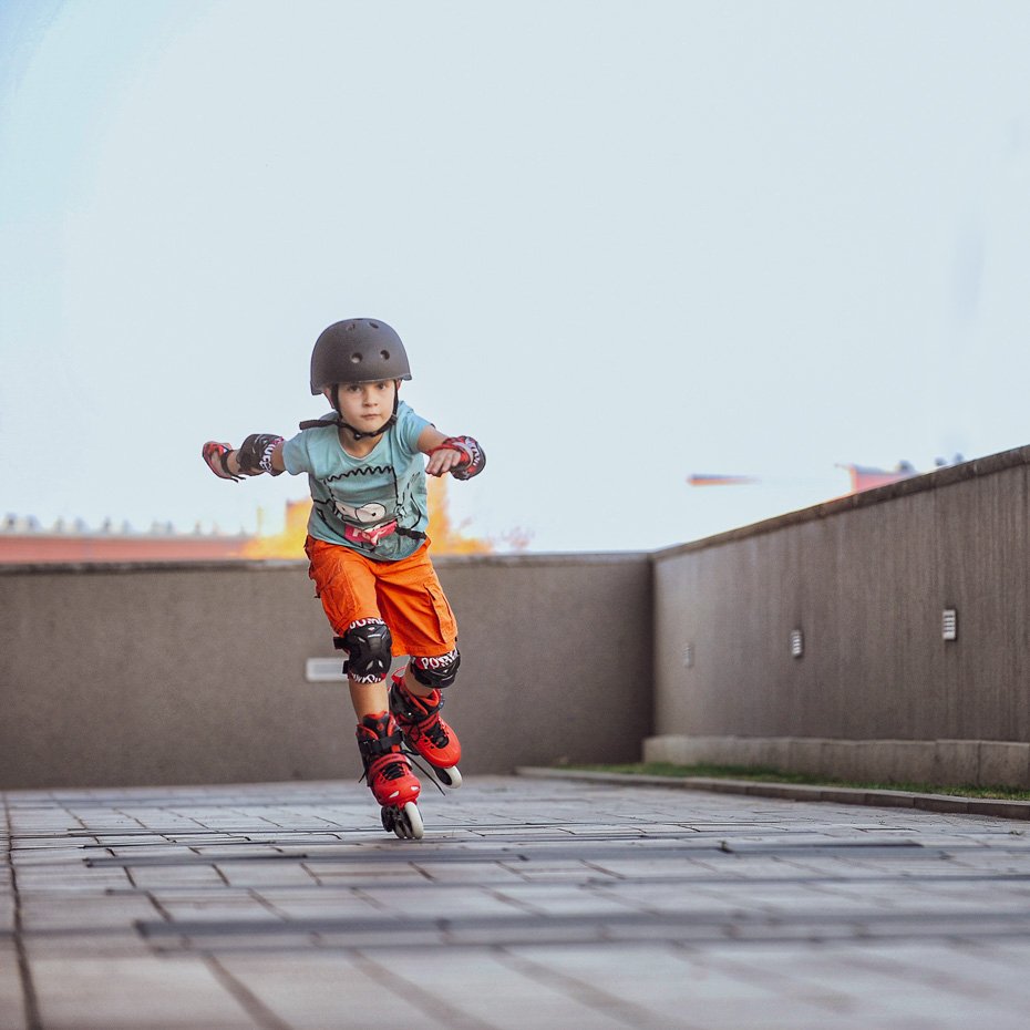 Boy riding on hard boot inline skates for kids