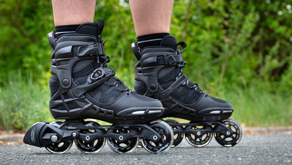 Feet of rollerblader wearing aggressive inline skates grinding on